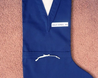 Personalized medical scrubs Christmas stocking. Perfect for the nurse or doctor in you life. It is accessorized with the name desired.