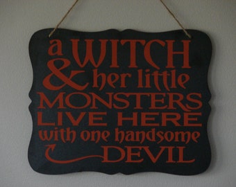 A witch & her little monsters live here with one handsome devil. hanging sign, Plaque, with vinyl saying halloween