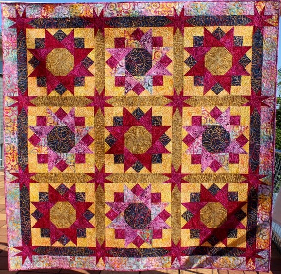 Quilt Pattern Spinning Stars in Gold and Maroon finished