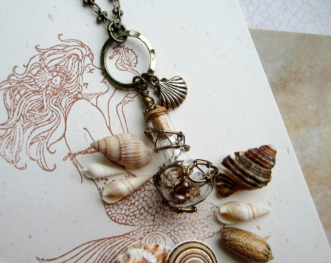 Enchanted necklace "Mermaid Soul" with wire wrapped glass vial filled with golden pearls and Swarovski crystals.