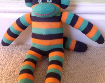 Eddie the green and orange striped sock monkey