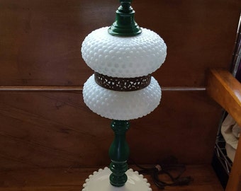 Hobnail emerald green lamp with brass trim.