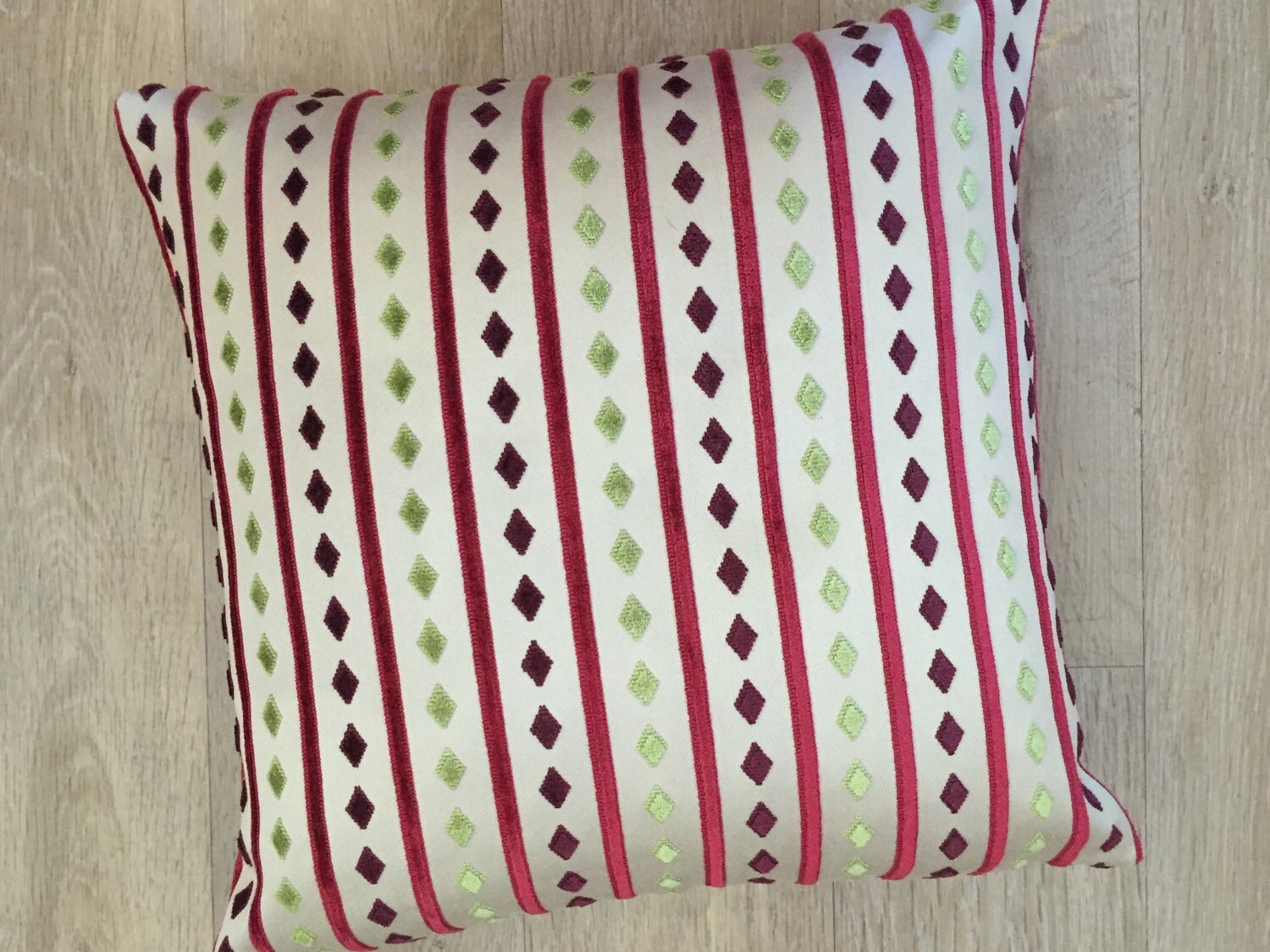 Raspberry Pink striped cushion cover on light beige linen with