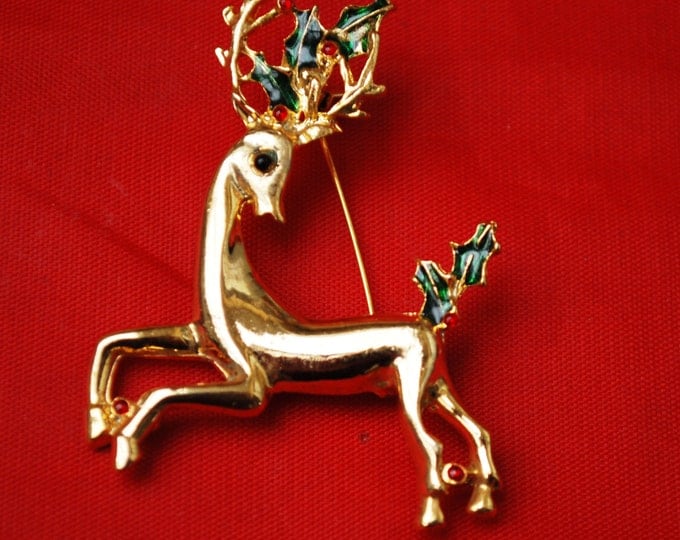 Vintage Christmas Reindeer Brooch Gold tone with red rhinestones and green enamel Holly Holiday Pin