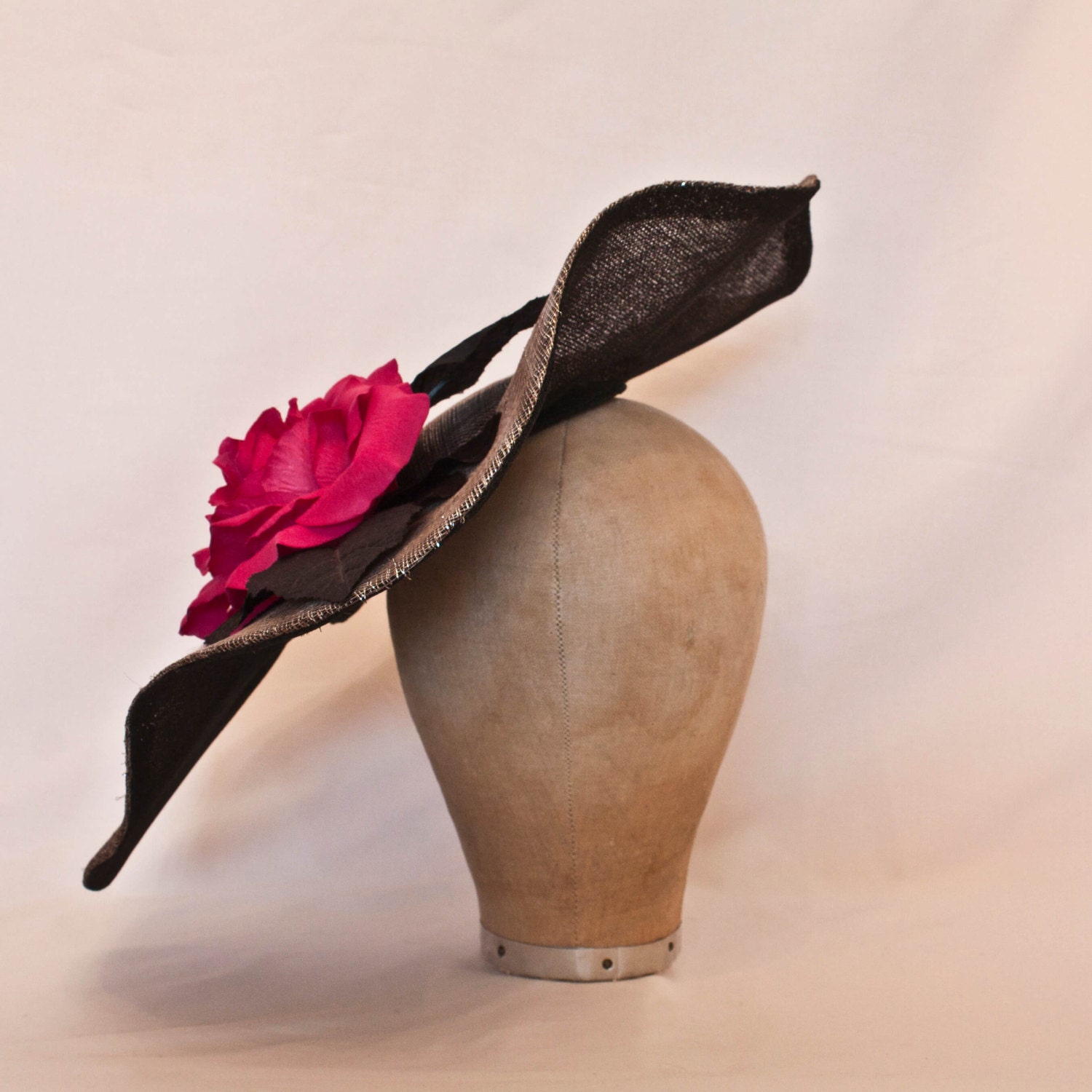 Stunning handmade gunmetal coloured contrast hat decorated with a large hot pink rose