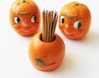 Kitschy Florida souvenir salt and pepper shakers and orange toothpick holder, anthropomorphic oranges, travel memorabilia, Florida souvenir