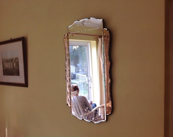 Beautiful vintage bevel edged Art Deco wall mirror with rose coulored glass panels and etched designs. 1940's