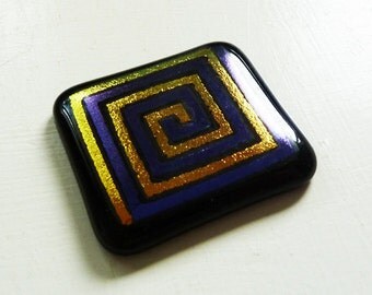 Dichroic cabochon - large black, purple and gold fused glass with purple and gold square spiral