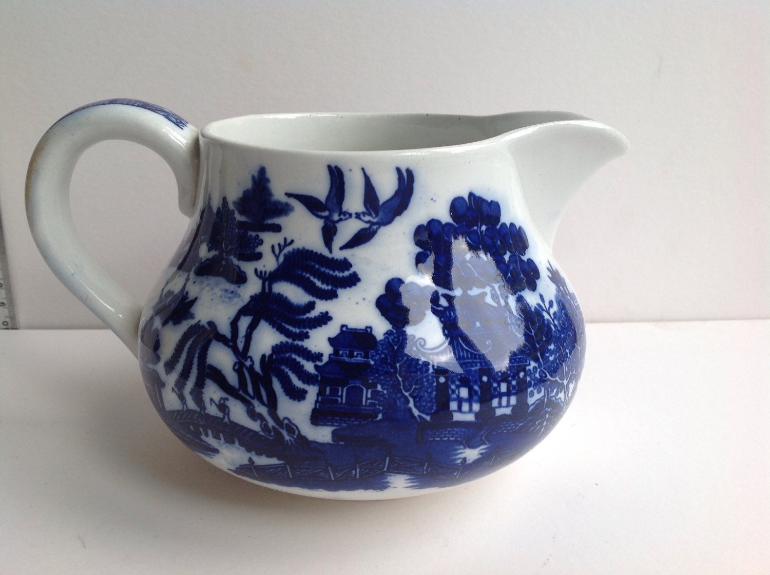 Antique Doulton willow pattern blue and white jug