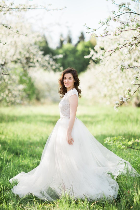 Items similar to Fluffy wedding dress with translucent asymmetrical ...