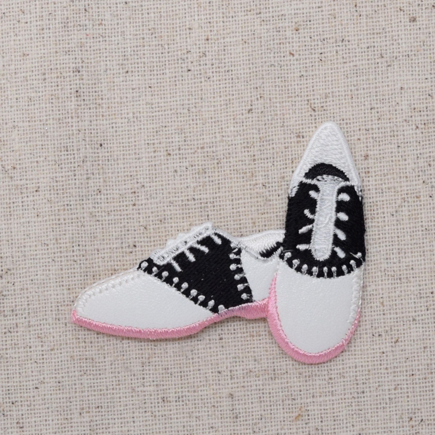 pink and white saddle shoes