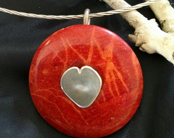 Red coral donut with sterling silver heart baille.