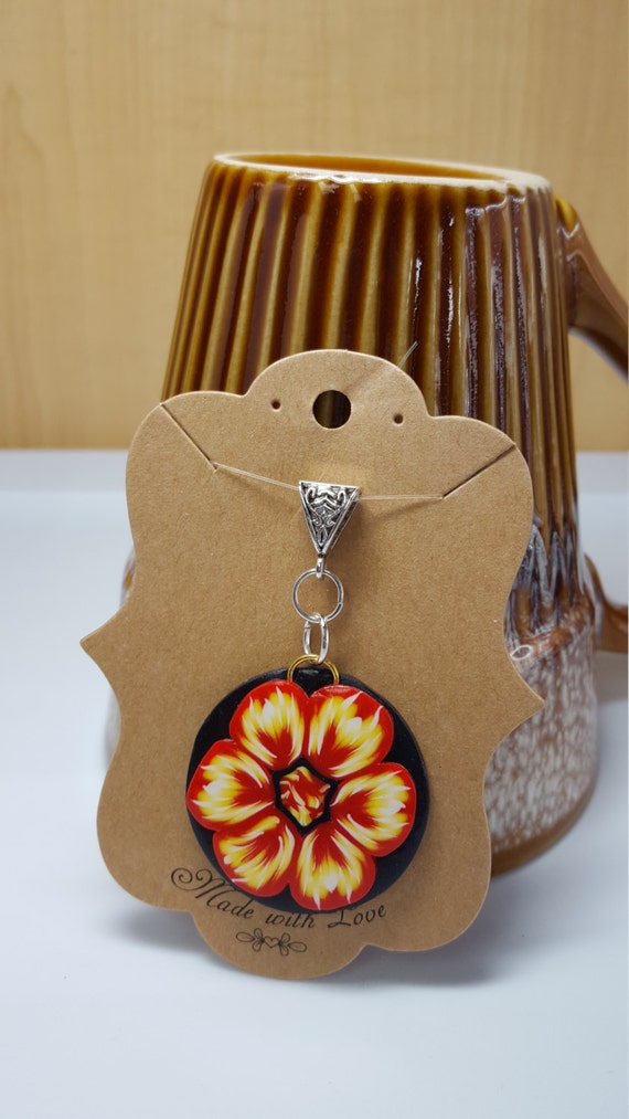 Items similar to Polymer clay Fire flower pendant on Etsy