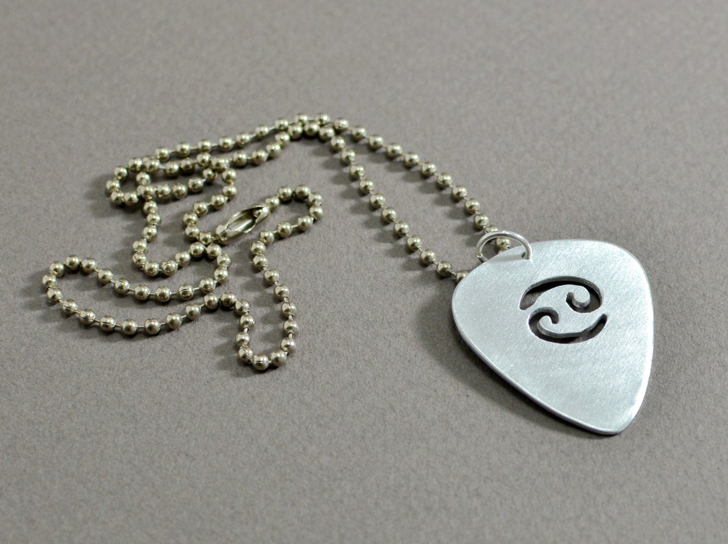 Zodiac guitar pick pendant in sterling silver with by NiciLaskin