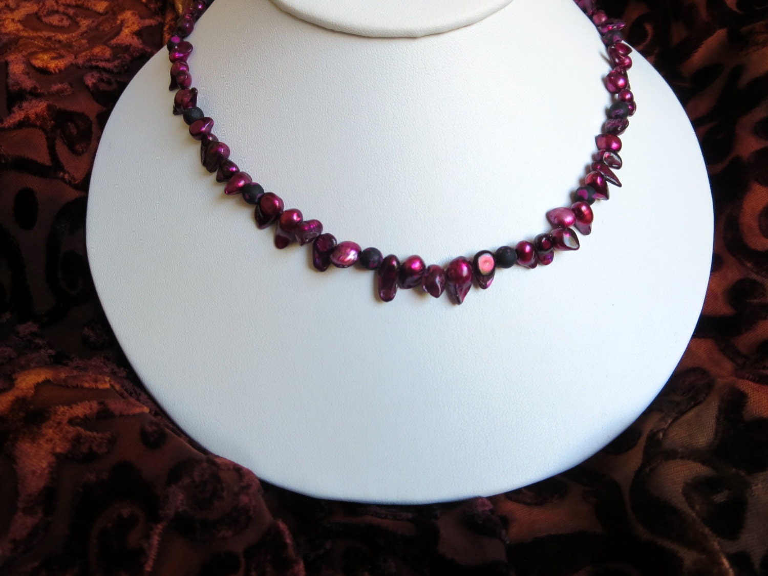 Delicately deformed burgundy colored pearls necklace