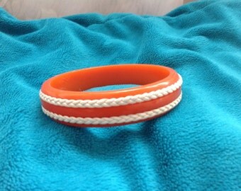 Vintage orange Bakelite bangle bracelet with leather decoration