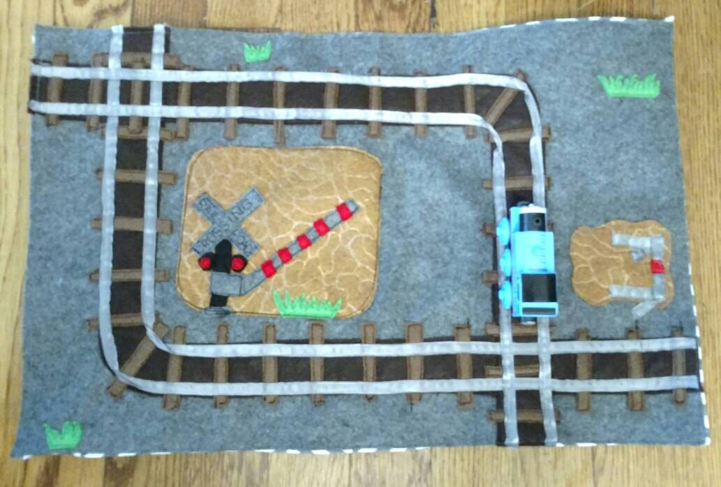 Felt toy train mat travel play mat rolls up.