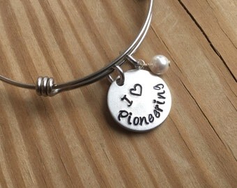 JW Pioneering Bracelet- Hand-Stamped "I (heart) Pioneering" Bracelet with an accent bead in your choice of colors