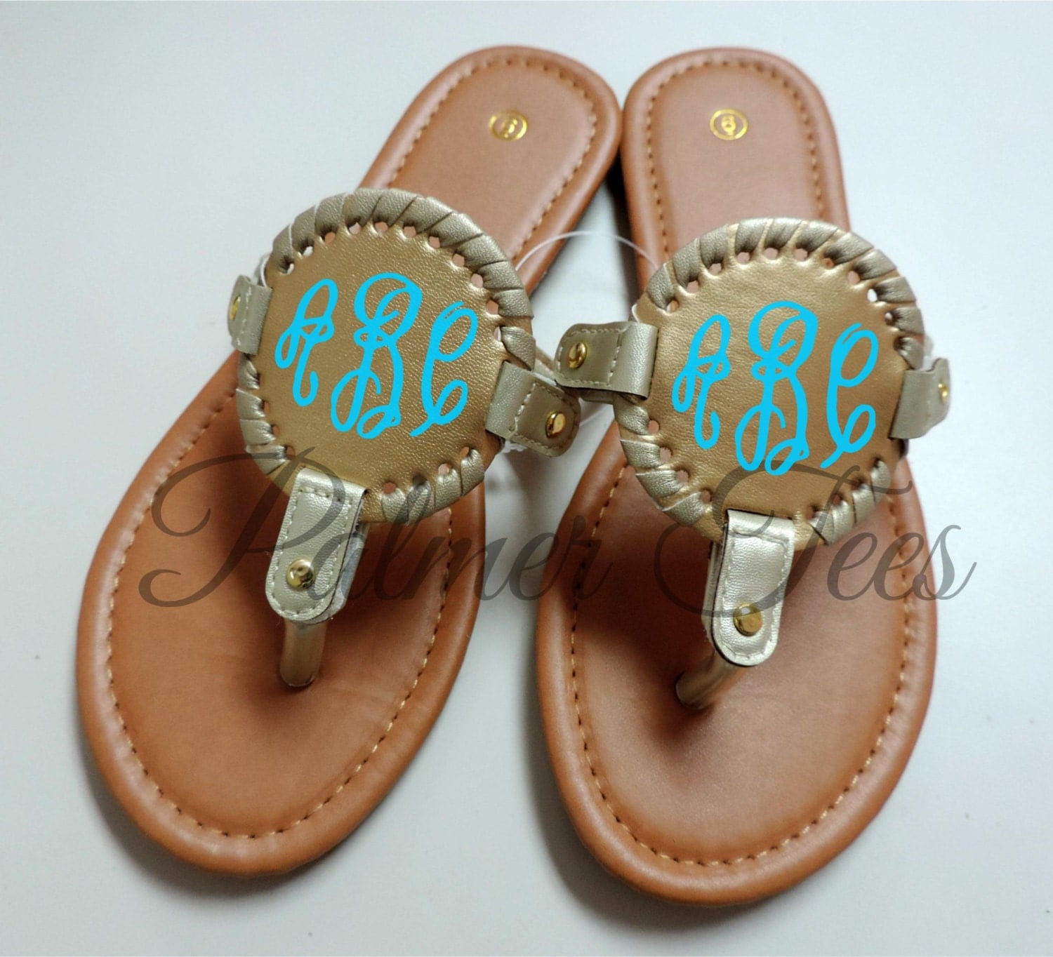 flip flops with gold medallion