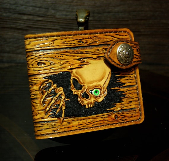 Hand-tooled leather wallet wood-like design with a skull