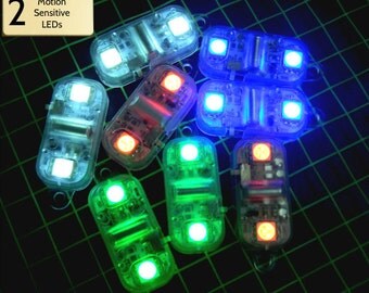 Burning Man Fairy Lights. Motion-activated Pulse Lights with on/off switch. Eyelet+metal clip or 2-sided tape. For Costumes / EDM clothing.