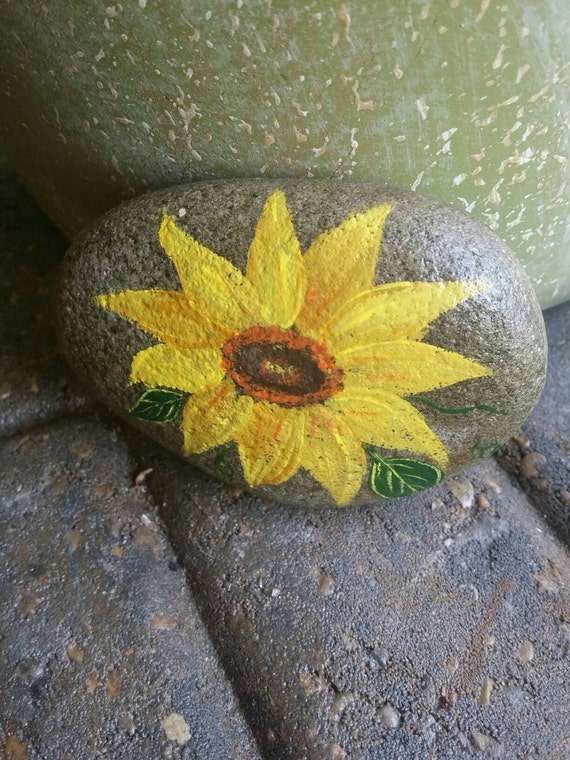 Rock art featuring a painted sunflower