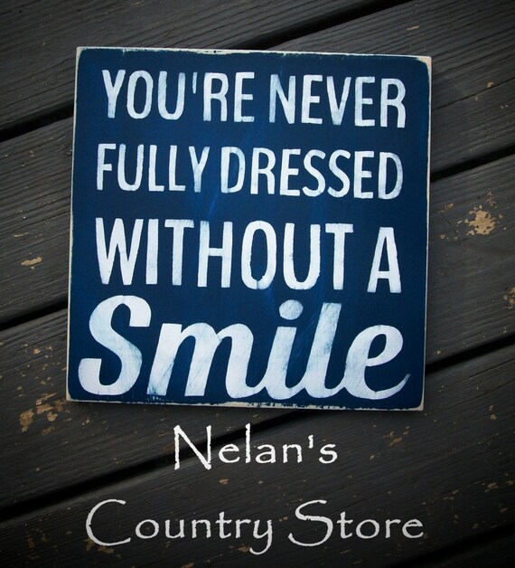 Never Fully Dressed Without A Smile hand painted sign