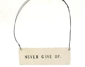 never give up ... inspiring tag ... hanging porcelain sign