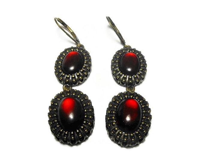Nina Ricci earrings, dangling opaque red oval cabochons framed in ornate bronze colored metal, lever back earrings, free swinging