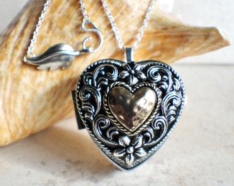 Music box locket, heart shaped locket with music box inside, in silver tone with heart on front cover.