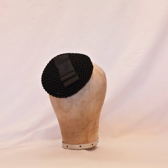 Handmade black cord swirl fascinator/hat decorated with structured bow