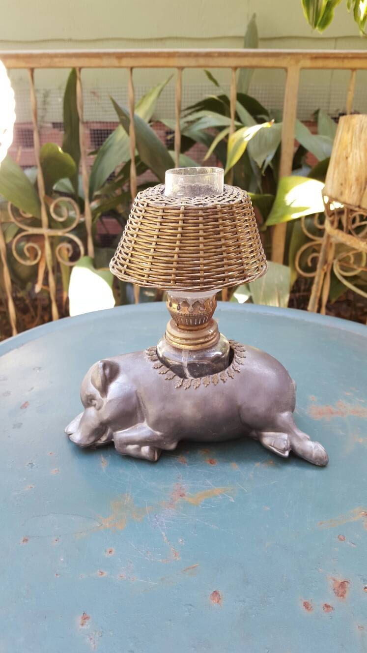 Vintage Petites Choses pewter pig with oil lamp.