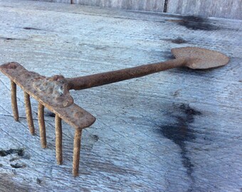 Primtive toy metal shovel and rake combination