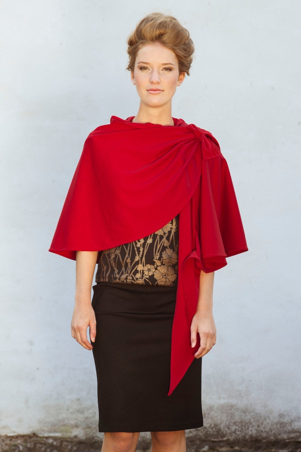 Hooded cape wrapped over the shoulder