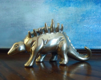 brass dinosaur figurine