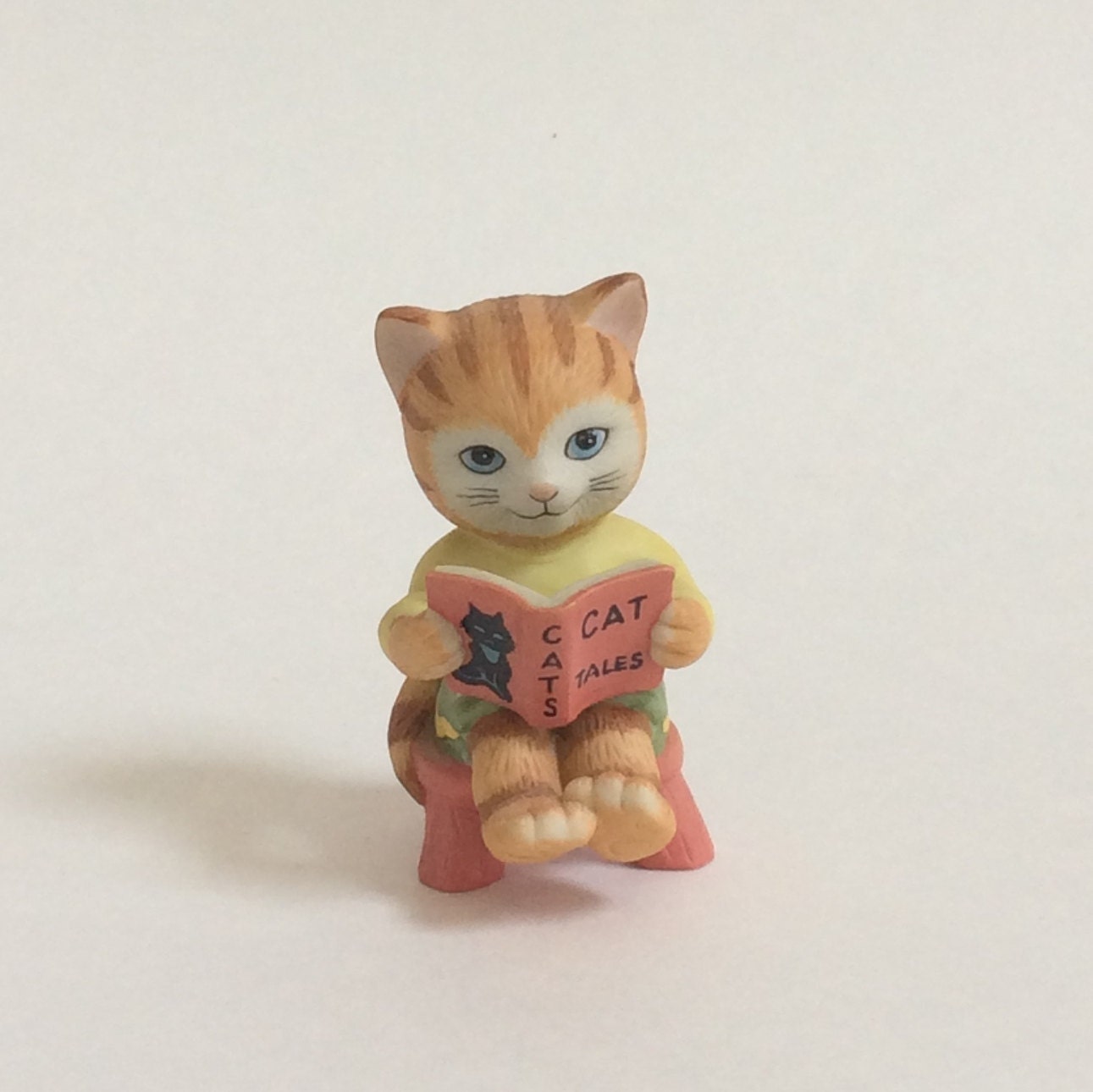 cat reading figurine