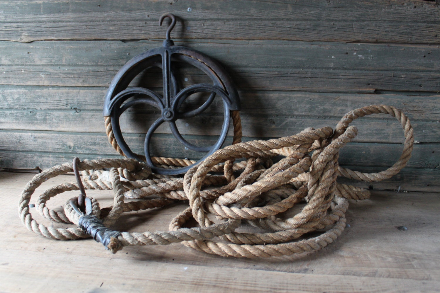 Large pulley wheel with length of hemp rope