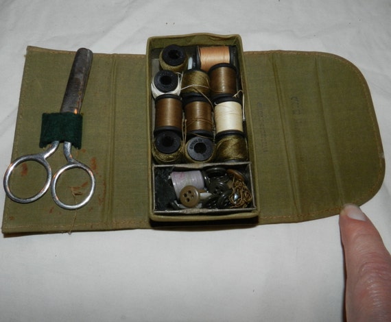 Vintage WWII military sewing kit with appropriately colored