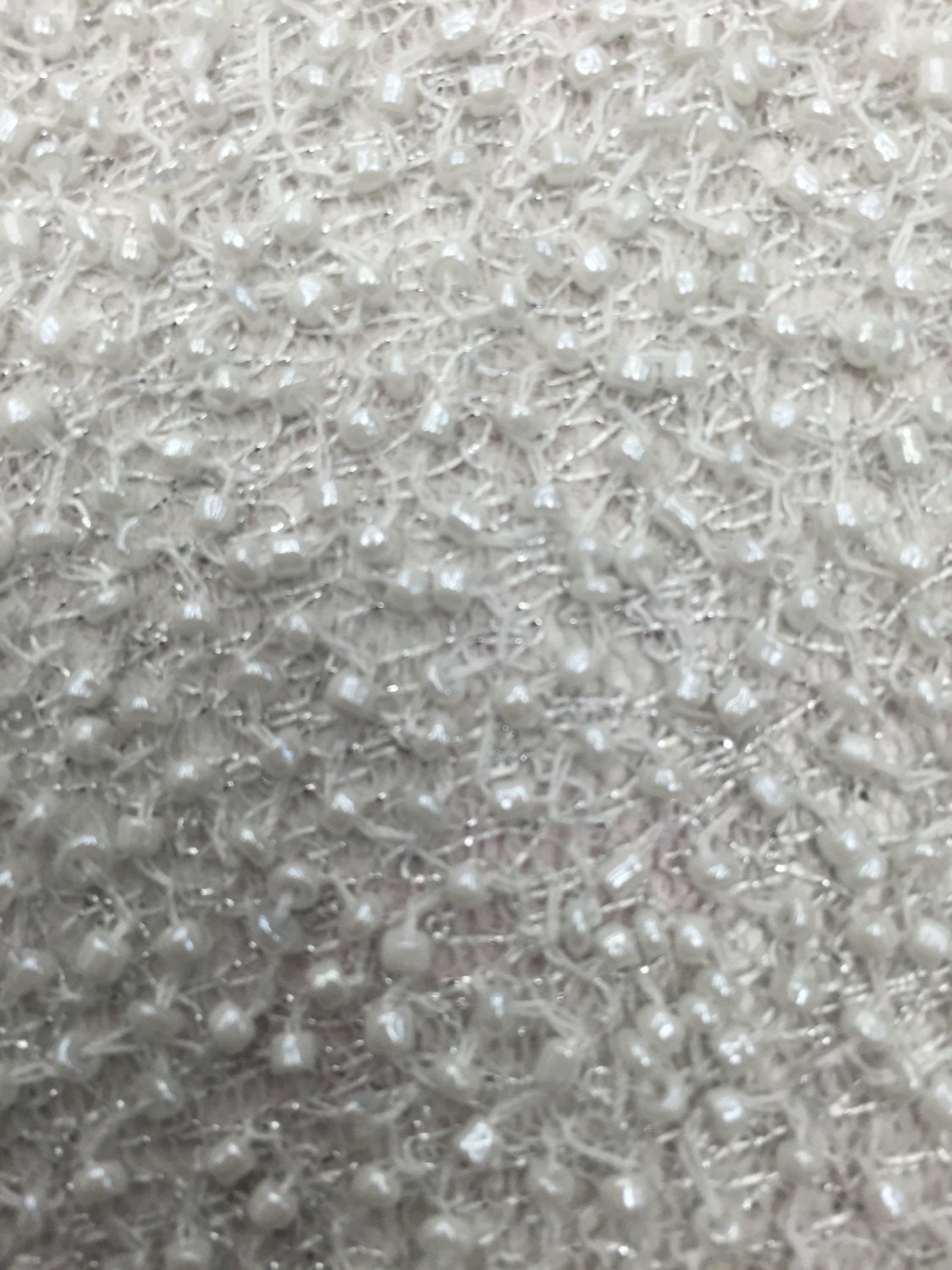 Hand made beaded pearl white on white net fabric sold by