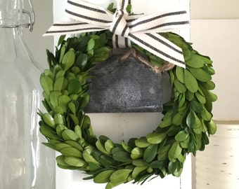 Boxwood wreath with striped ribbon, added galvanized chalkboard tin label.