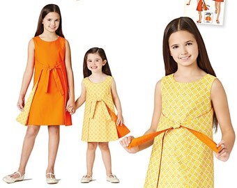 Girls' Jiffy Reversible Wrap Dress. Size 3-6 and 7-14. Simplicity 8104. Pattern is new and uncut.