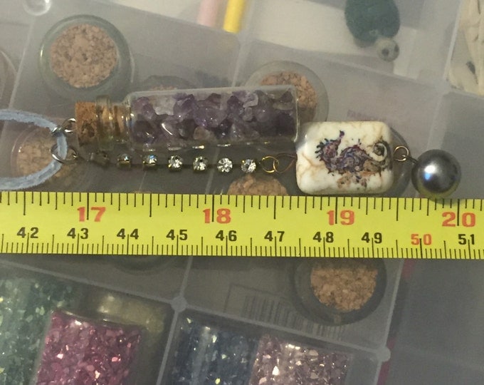 Amethyst gemstones in a mini bottle