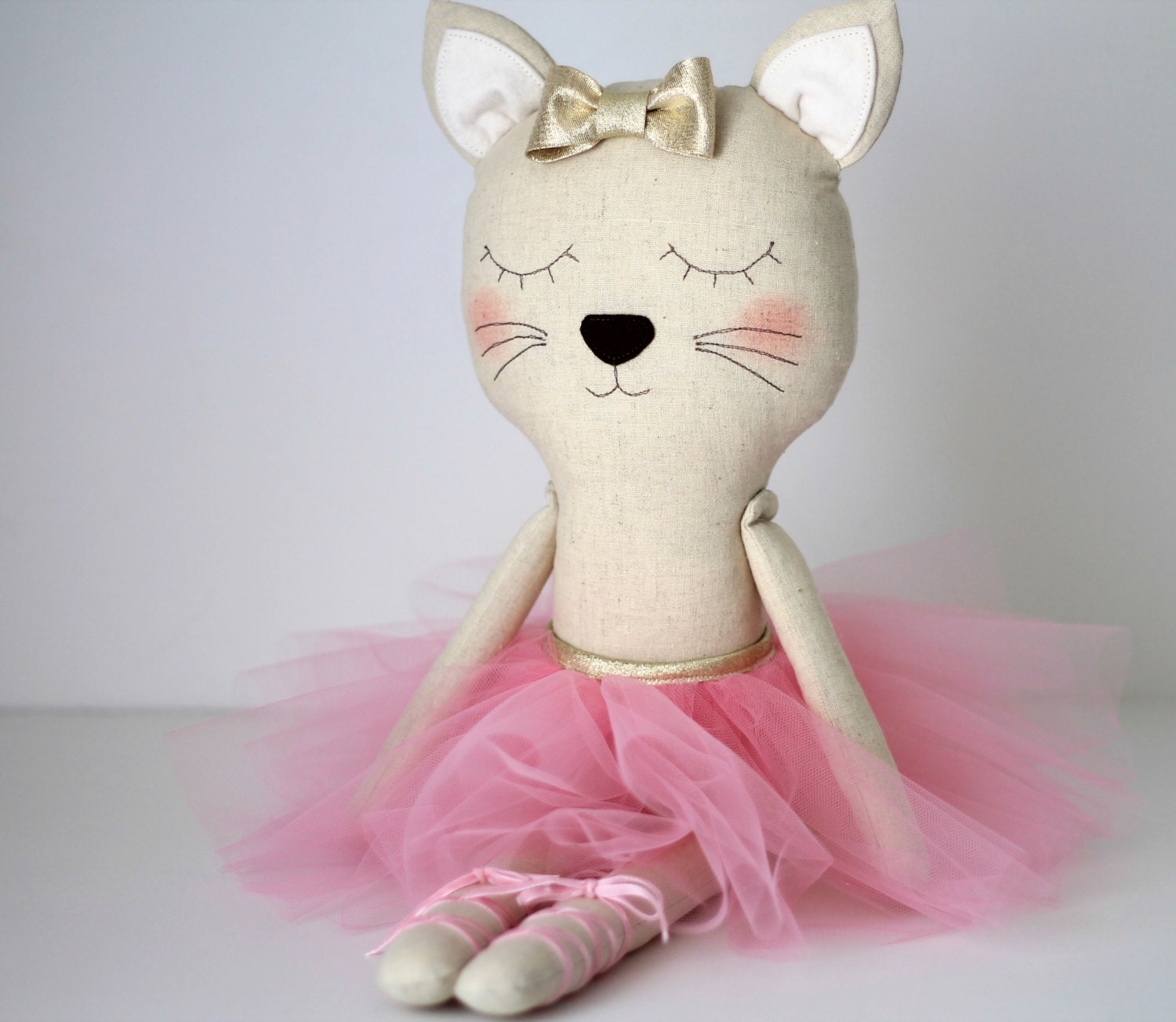 Cat ballerina in a pink tutu and a golden bow. Stuffed by blita