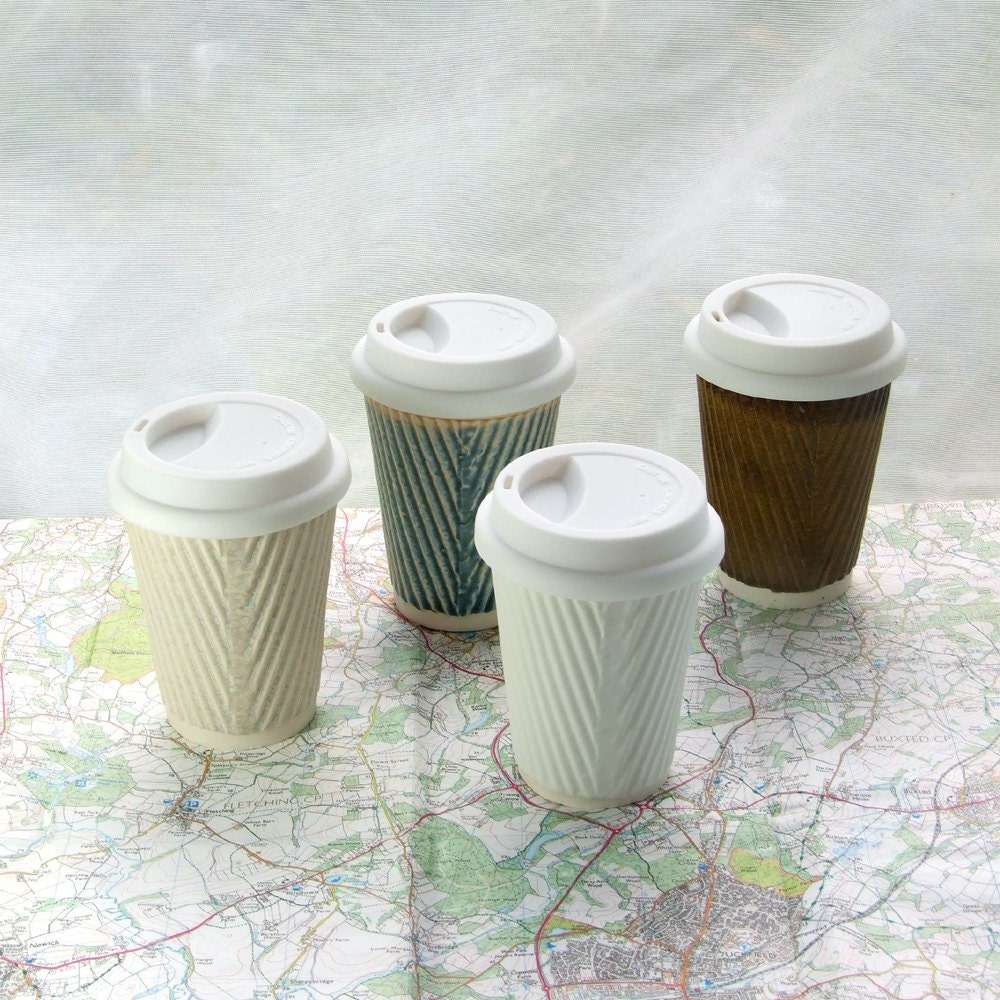 Coffee cup or ceramic travel mug with lid. White porcelain