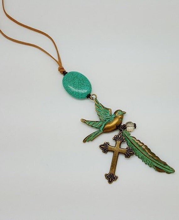 Items similar to Handmade necklace dove with cross and feather on Etsy