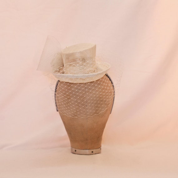 Handmade ivory mini top hat, decorated with rose and veiling
