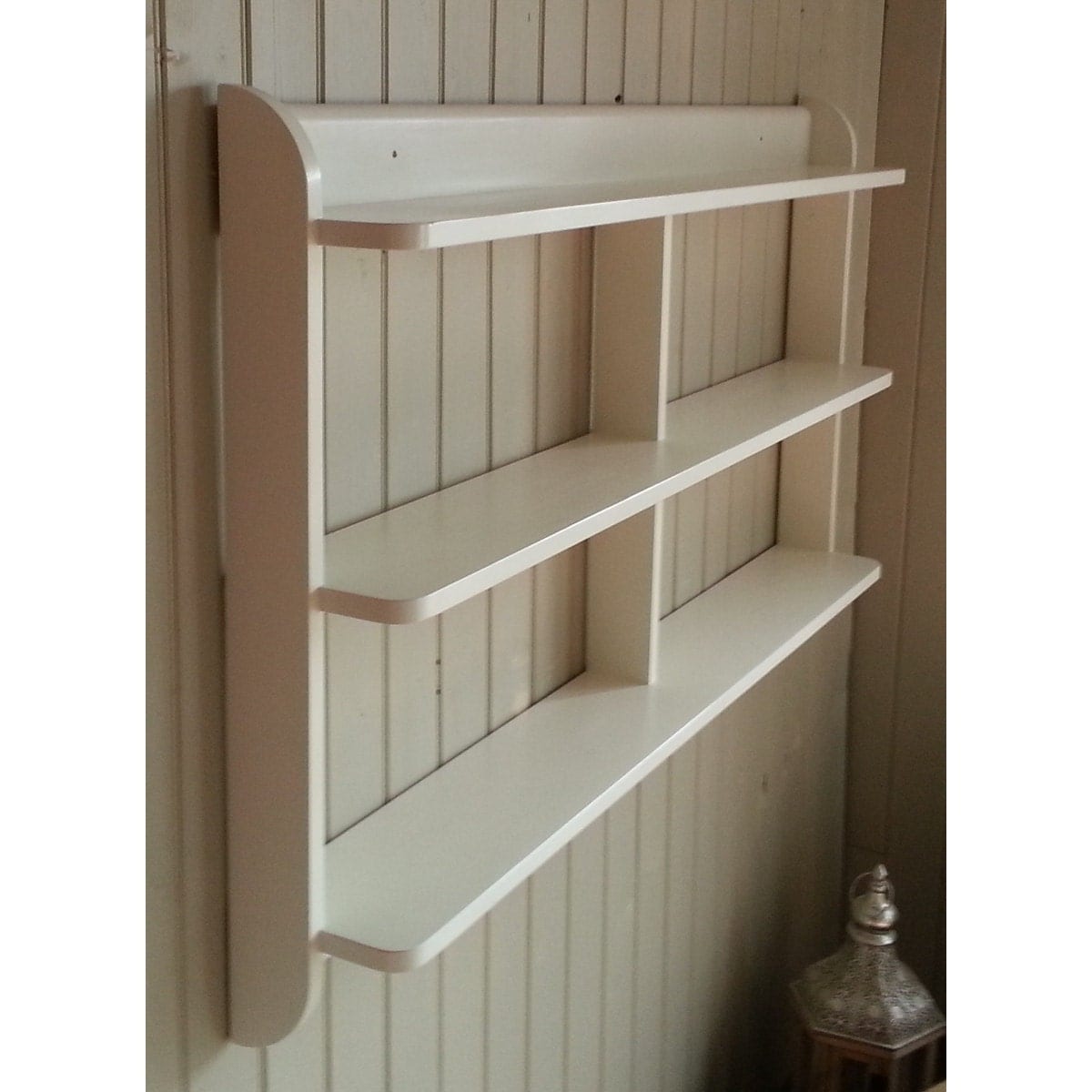 Wide wall mounted open back shelf unit. Painted kitchen