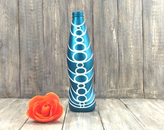 Blue metallic painted bottle with white geometric pattern