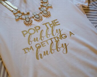Pop the bubbly i'm getting a hubby, Pop the bubbly shirt. Bride T-shirt. Bride V-neck Shirt. V-neck Tshirt. Bride to be Gift. Bride tshirt