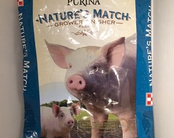 Recycled animal feed sack garment bag with back zipper and coated hanger. Can be made from many different animal feed sacks.